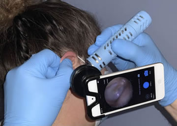 The inside of the ear is visible on the screen using a tiny camera with a light.